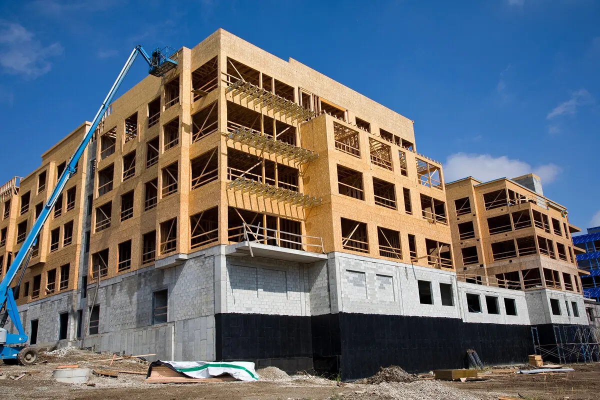 Building under construction with boom lift