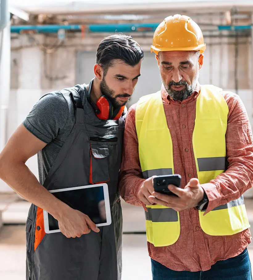Workers looking at smartphone